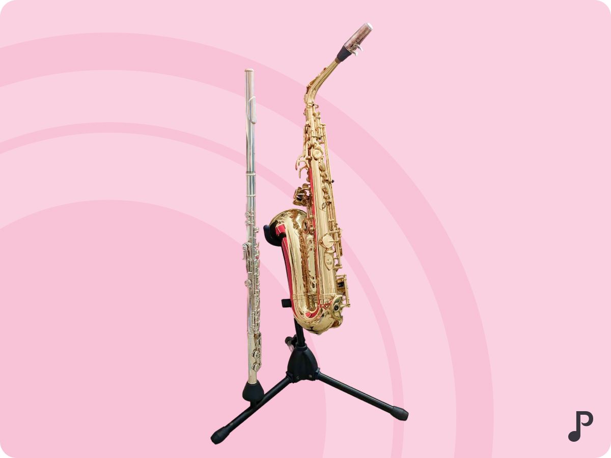 A flute and saxophone assembled on a stand